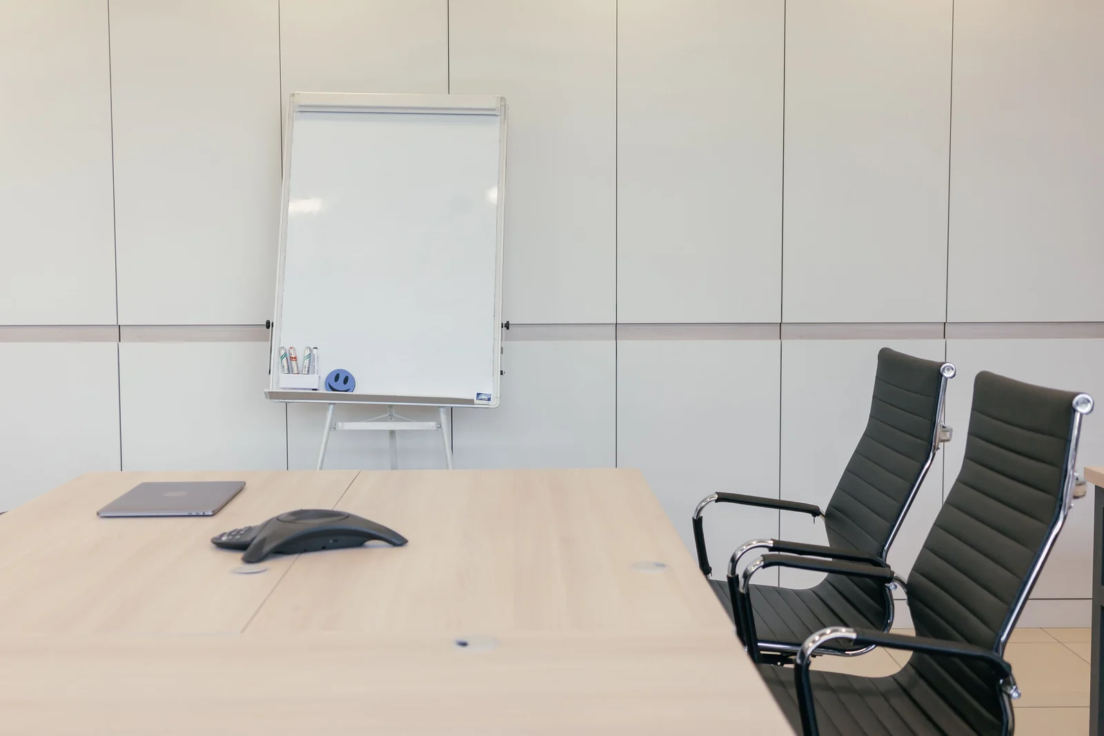 Meeting room with a conference phone and whiteboard